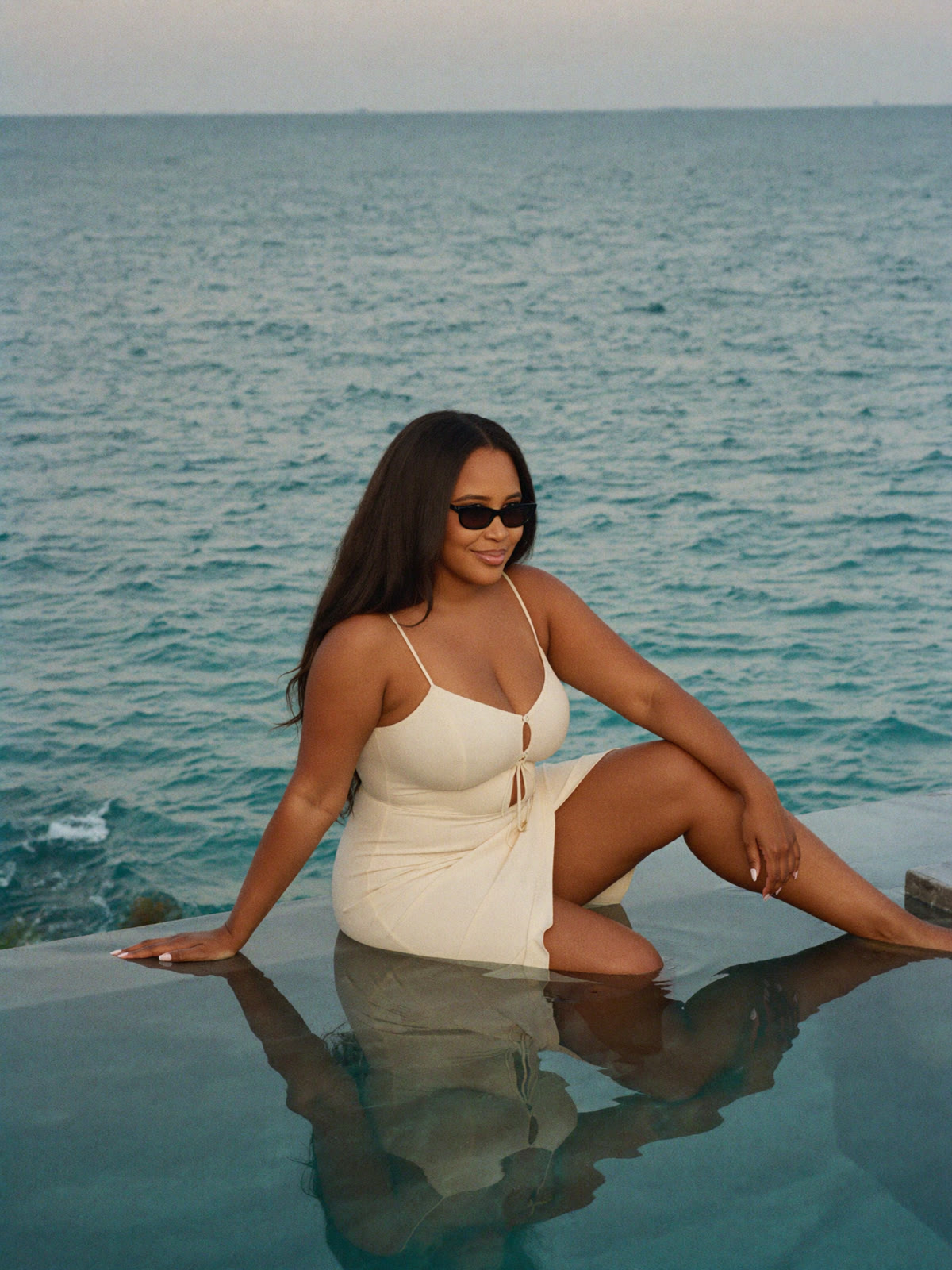 Brittany at a luxury infinity pool overlooking the ocean